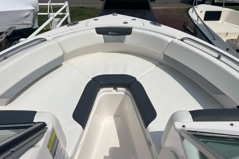 Slide: The Image of 2022 Robalo R227 Dual Console boat with spacious white seating area. - 9