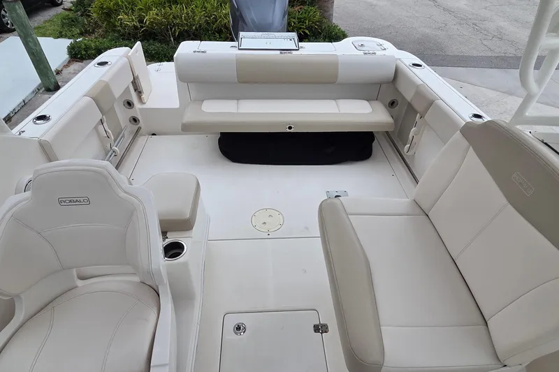 Slide: The Image of 2017 Robalo R247 Dual Console boat interior with beige seating and spacious layout. - 10