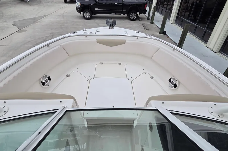 Slide: The Image of 2017 Robalo R247 Dual Console boat interior with spacious seating and speakers. - 11