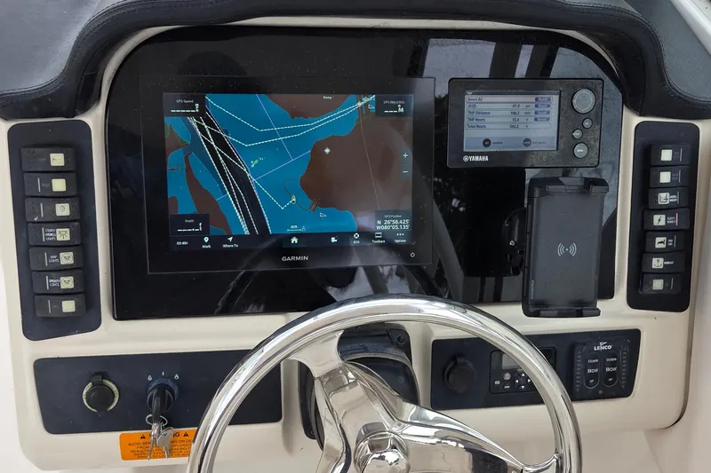 Slide: The Image of Control panel of a 2017 Robalo R247 Dual Console with Garmin navigation system. - 13