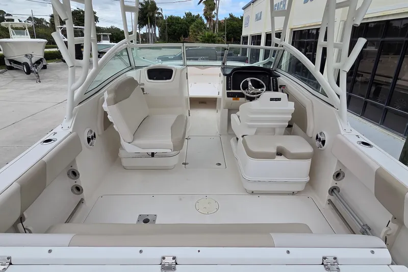 Slide: The Image of 2017 Robalo R247 Dual Console boat interior with seating and steering wheel. - 16
