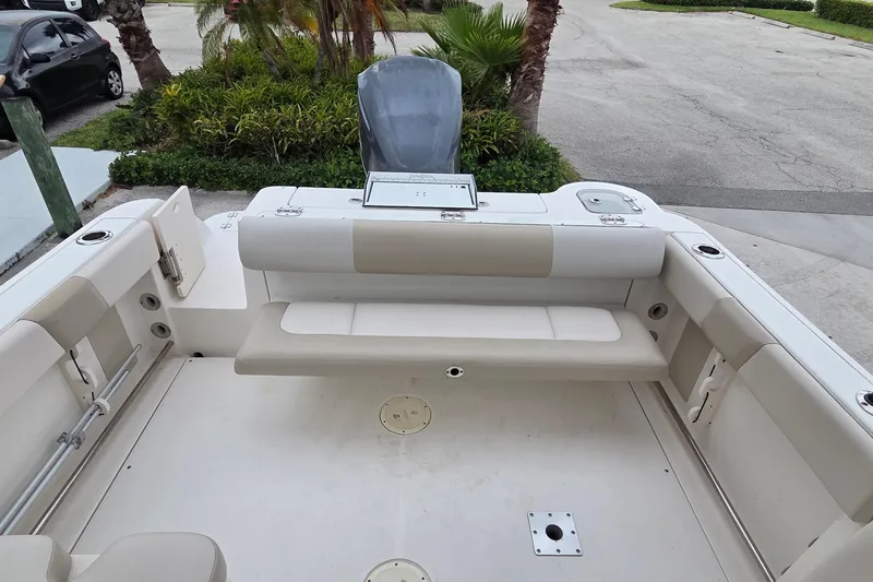 Slide: The Image of 2017 Robalo R247 Dual Console boat interior with seating and storage compartments. - 6