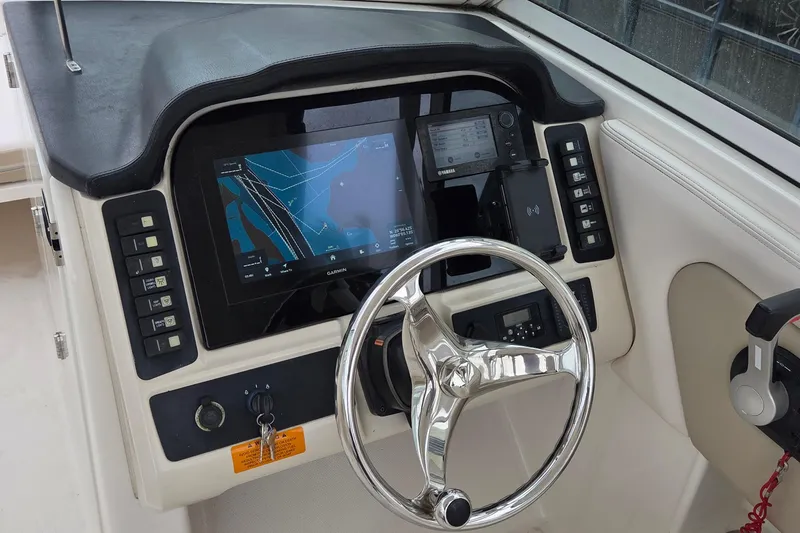 Slide: The Image of 2017 Robalo R247 Dual Console helm with Garmin navigation and Yamaha controls. - 7