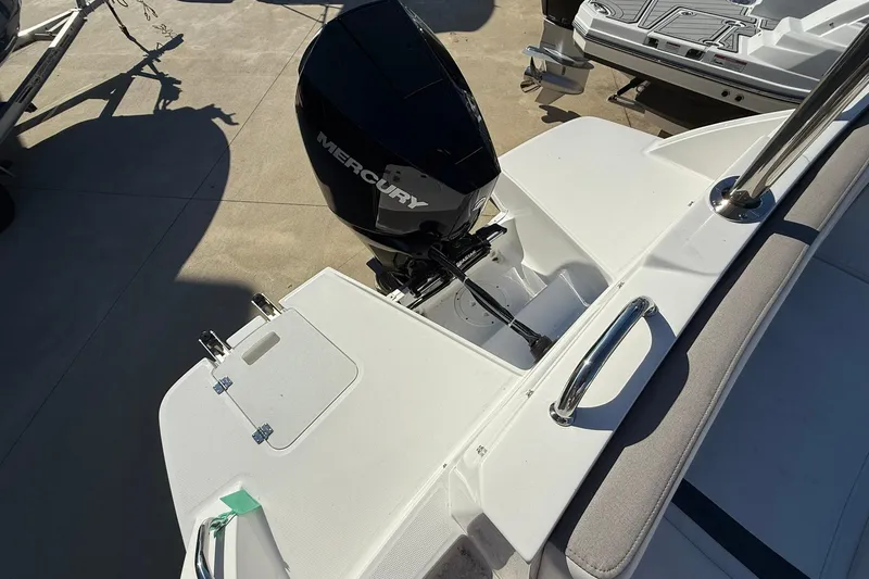 Slide: The Image of 2025 Hurricane SunDeck 235 OB boat with Mercury outboard motor, rear deck view. - 16