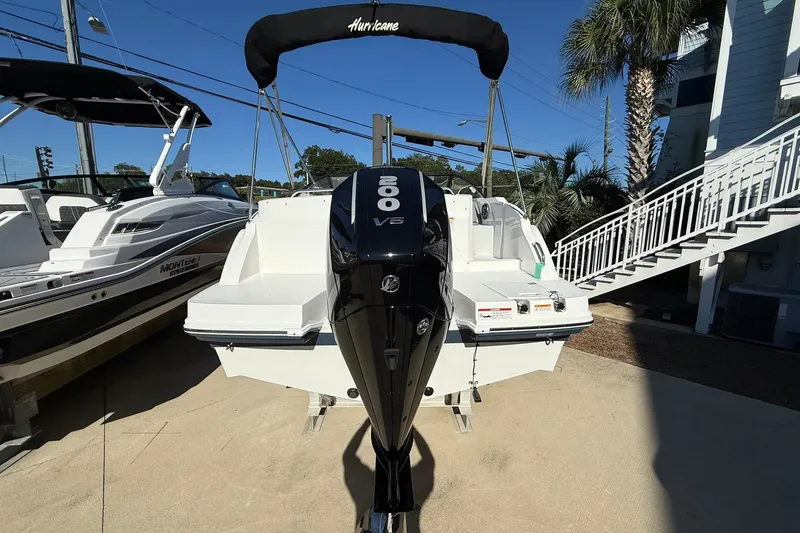 Slide: The Image of 2025 Hurricane SunDeck 235 OB boat with 200 V6 outboard motor, docked outdoors. - 4