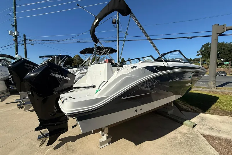 Slide: The Image of 2025 Hurricane SunDeck 235 OB boat with Mercury outboard engine on display. - 5