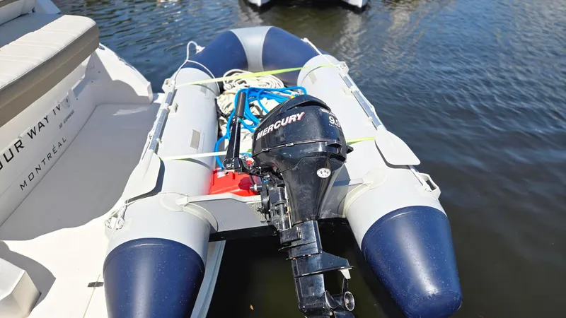 Slide: The Image of Inflatable boat with Mercury outboard motor docked beside 2017 Regal 32 Express. - 12