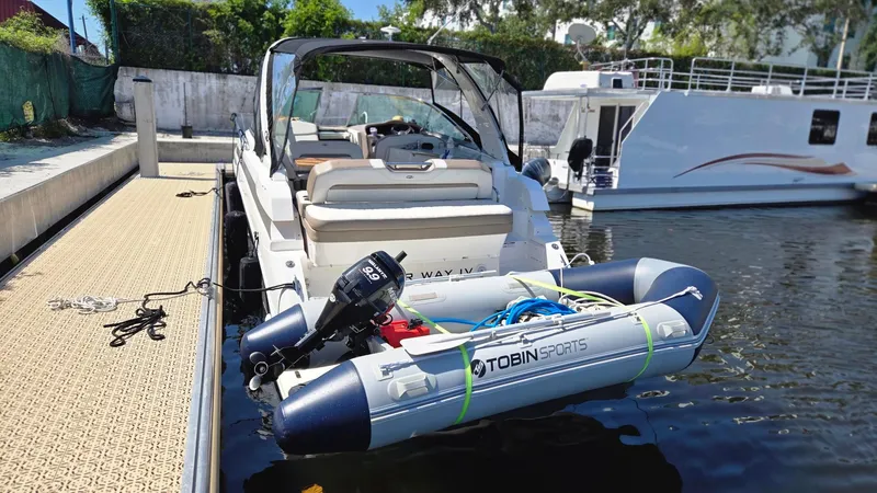 Slide: The Image of 2017 Regal 32 Express boat docked with inflatable Tobin Sports dinghy attached. - 13