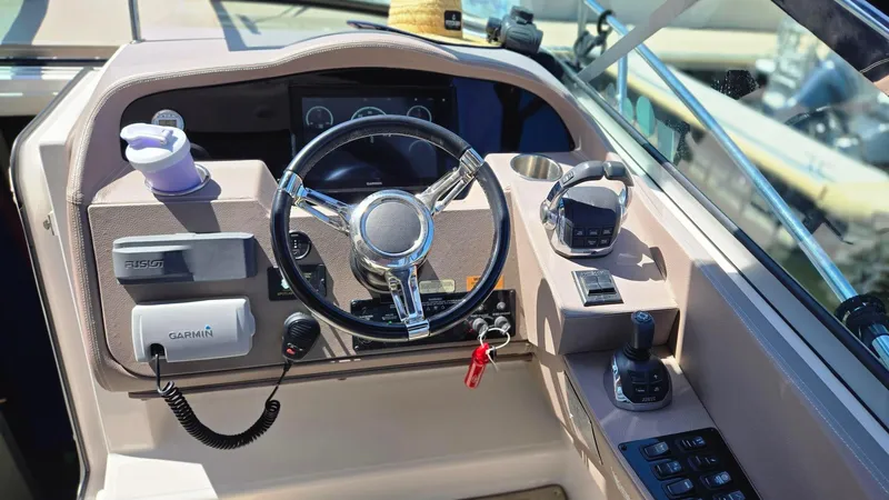 Slide: The Image of Cockpit of 2017 Regal 32 Express boat with steering wheel and navigation controls. - 5