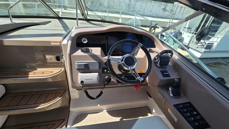 Slide: The Image of 2017 Regal 32 Express boat cockpit with steering wheel and control panel. - 6