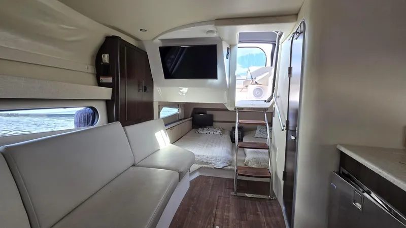 Slide: The Image of Interior of 2017 Regal 32 Express yacht with modern seating and sleeping area. - 8