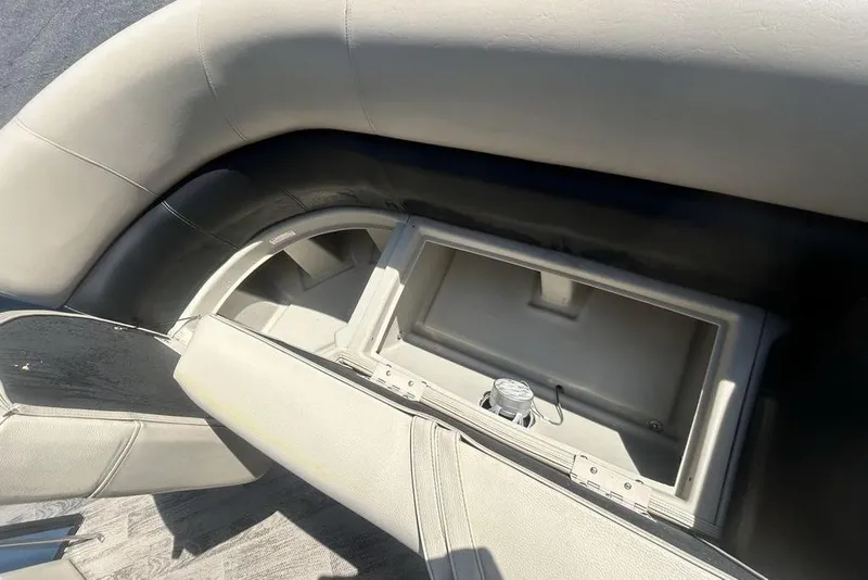 Slide: The Image of 2018 Manitou Aurora LE 22 RF boat seat storage compartment, open and empty. - 11