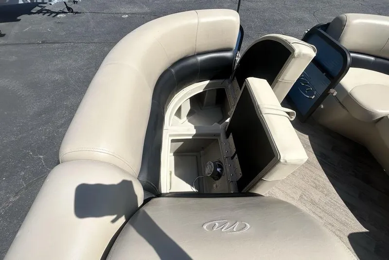 Slide: The Image of 2018 Manitou Aurora LE 22 RF boat interior with open storage compartments. - 12