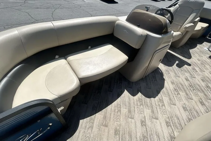 Slide: The Image of 2018 Manitou Aurora LE 22 RF boat interior with beige seating and helm. - 13