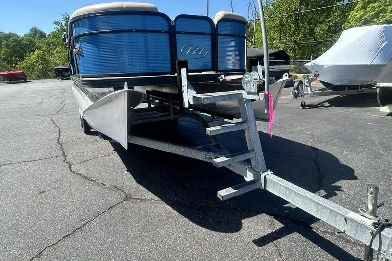 Slide: The Image of 2018 Manitou Aurora LE 22 RF Twin Tube pontoon boat on trailer in sunny outdoor setting. - 16