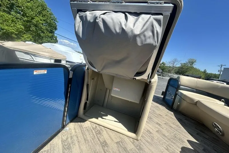 Slide: The Image of 2018 Manitou Aurora LE 22 RF Twin Tube boat interior with open storage compartment. - 17