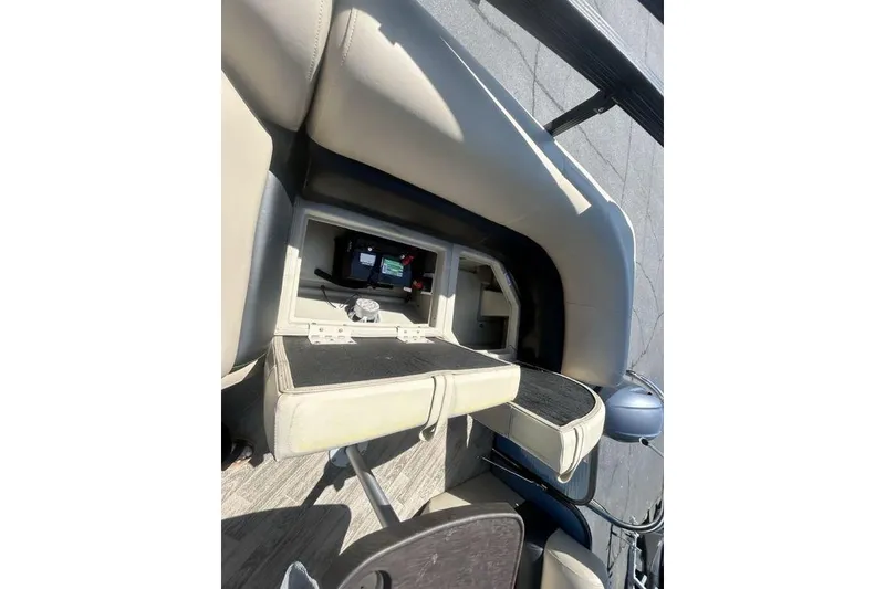Slide: The Image of 2018 Manitou Aurora LE 22 RF boat interior with open storage compartment. - 20