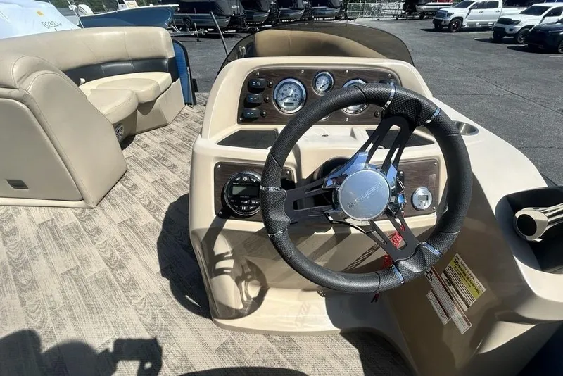 Slide: The Image of 2018 Manitou Aurora LE 22 RF Twin Tube boat interior with steering wheel and dashboard. - 7