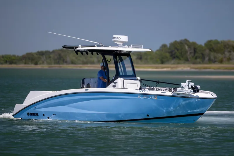The Image of 2025 Yamaha Boats 255 FSH Sport H cruising on a calm lake. - 0