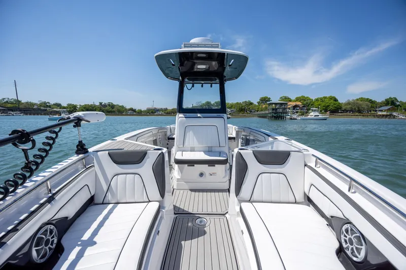 Slide: The Image of 2025 Yamaha Boats 255 FSH Sport H on water, showcasing sleek interior design. - 13