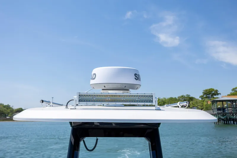 Slide: The Image of Radar equipment on 2025 Yamaha Boats 255 FSH Sport H against clear blue sky. - 14