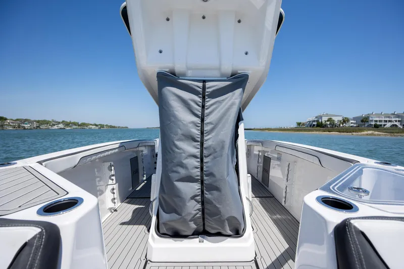 Slide: The Image of 2025 Yamaha Boats 255 FSH Sport H on water, showcasing spacious deck and sleek design. - 15