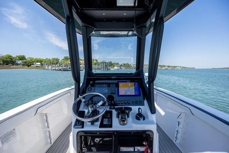 Slide: The Image of 2025 Yamaha Boats 255 FSH Sport H dashboard with navigation system on open water. - 18