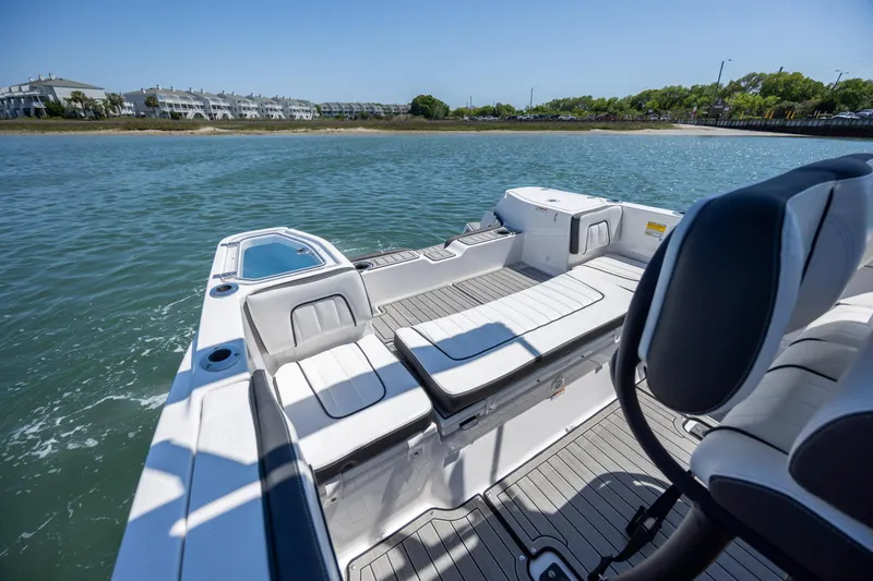 Slide: The Image of 2025 Yamaha Boats 255 FSH Sport H on water, showcasing sleek seating and modern design. - 24