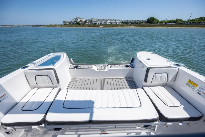 Slide: The Image of 2025 Yamaha Boats 255 FSH Sport H, spacious deck, scenic waterfront view. - 25