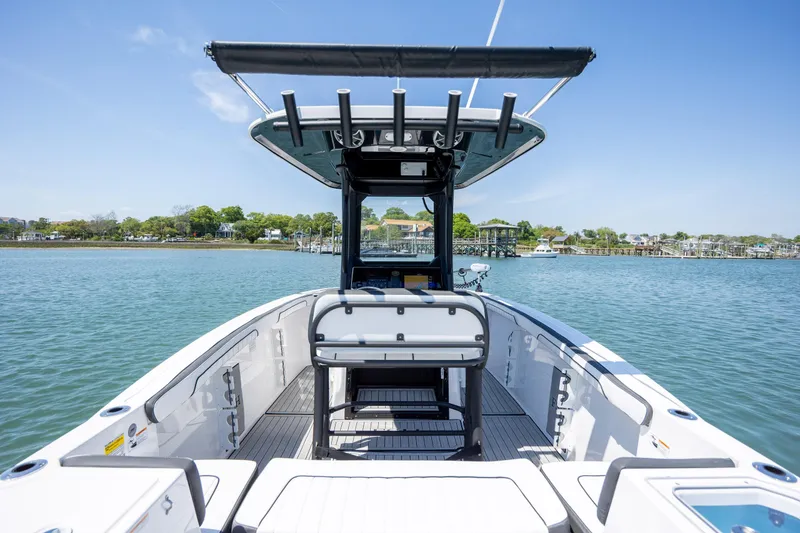 Slide: The Image of 2025 Yamaha Boats 255 FSH Sport H on water, showcasing sleek design and spacious deck. - 29