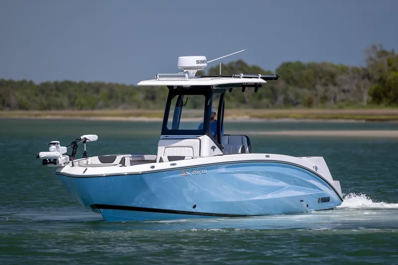Slide: The Image of 2025 Yamaha Boats 255 FSH Sport H cruising on a serene lake. - 6