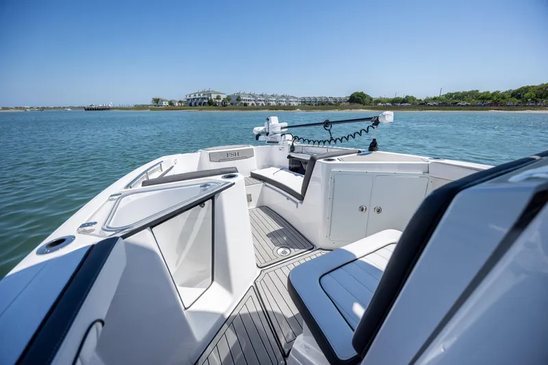 Slide: The Image of 2025 Yamaha Boats 255 FSH Sport H on calm water, showcasing sleek interior design. - 8