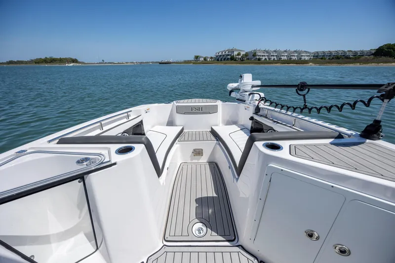 Slide: The Image of 2025 Yamaha Boats 255 FSH Sport H on calm water, showcasing sleek deck design. - 9