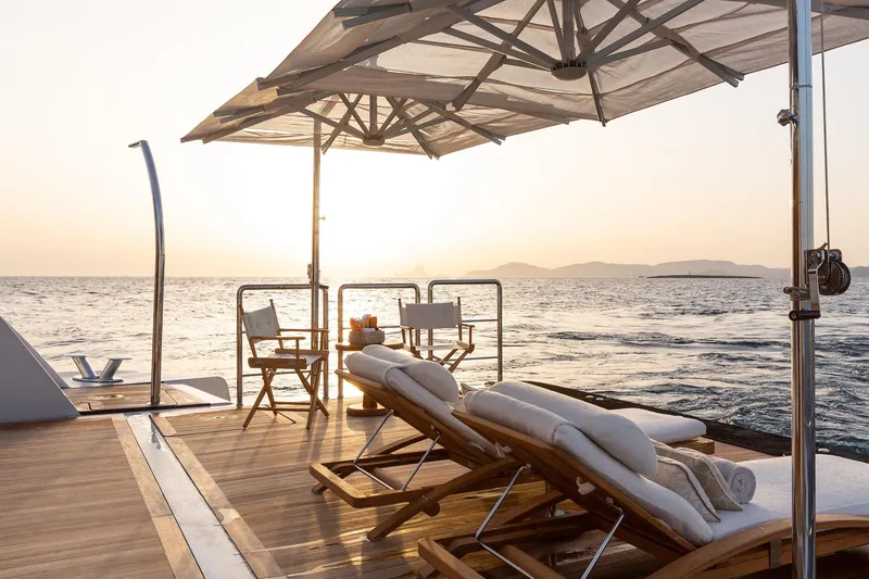 Slide: The Image of Luxurious Alia Yachts 60M deck with sun loungers and ocean view at sunset, 2016 model. - 3