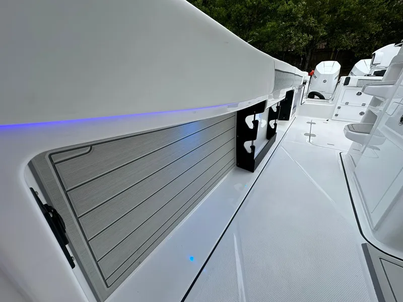Slide: The Image of 2024 Blackfin 400 CC boat deck with rod holders and sleek design. - 32
