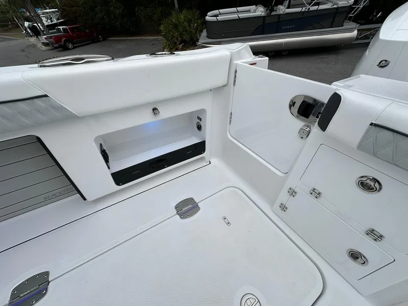 Slide: The Image of 2024 Blackfin 400 CC boat interior with storage compartments and seating area. - 33