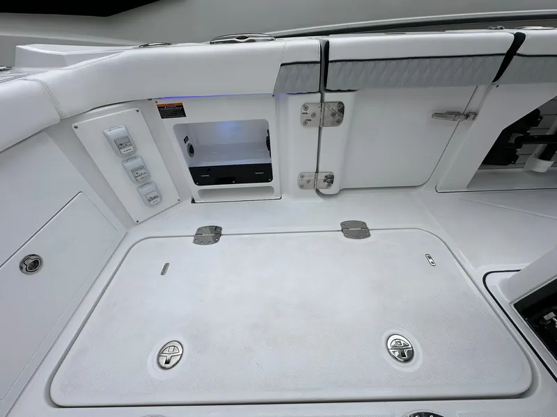 Slide: The Image of 2024 Blackfin 400 CC boat interior, featuring storage compartments and control panel. - 38