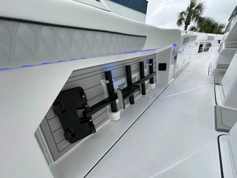 Slide: The Image of 2024 Blackfin 400 CC boat interior with rod holders and cushioned side panel. - 39