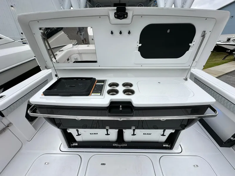Slide: The Image of 2024 Blackfin 400 CC boat with open storage compartments and built-in grill. - 42