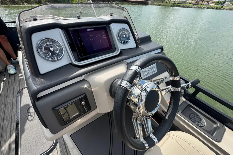 Slide: The Image of Steering console of 2021 Harris Solstice 230 boat with modern controls and display. - 12