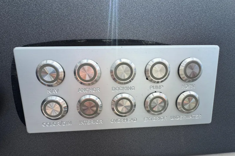 Slide: The Image of Control panel of a 2021 Harris Solstice 230 boat with labeled buttons. - 14