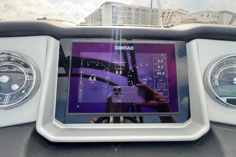 Slide: The Image of Dashboard of a 2021 Harris Solstice 230 boat with Simrad display and gauges. - 17