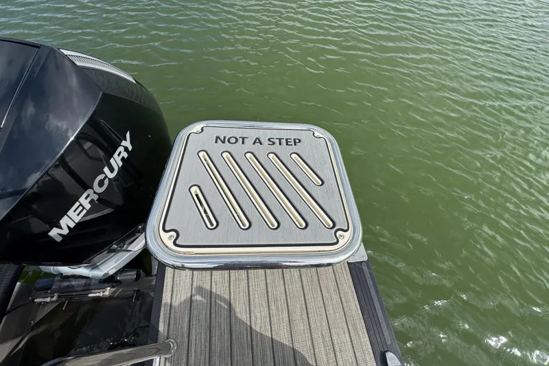 Slide: The Image of Harris Solstice 230 boat with Mercury engine, "Not a Step" warning on platform. - 23