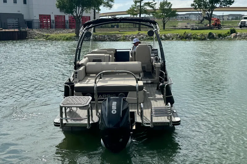 Slide: The Image of 2021 Harris Solstice 230 pontoon boat on water, rear view with outboard motor. - 6