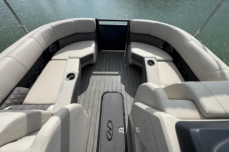 Slide: The Image of Luxurious seating on a 2021 Harris Solstice 230 pontoon boat, overlooking calm waters. - 7
