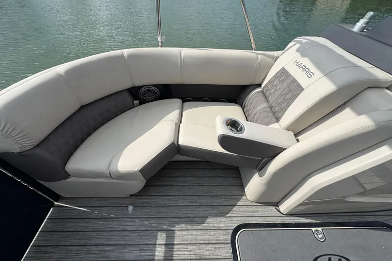 Slide: The Image of Luxurious seating on 2021 Harris Solstice 230 boat, featuring elegant upholstery and cup holder. - 8