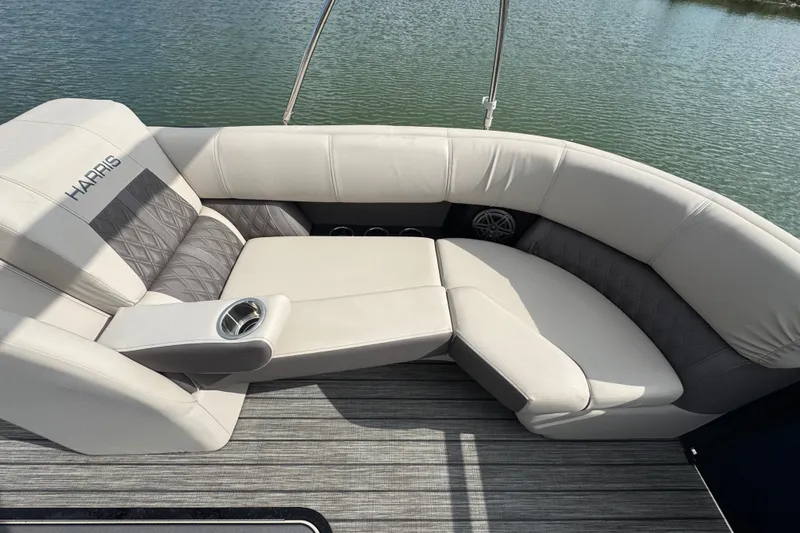Slide: The Image of Luxurious seating on 2021 Harris Solstice 230 boat, featuring elegant upholstery and cup holder. - 9