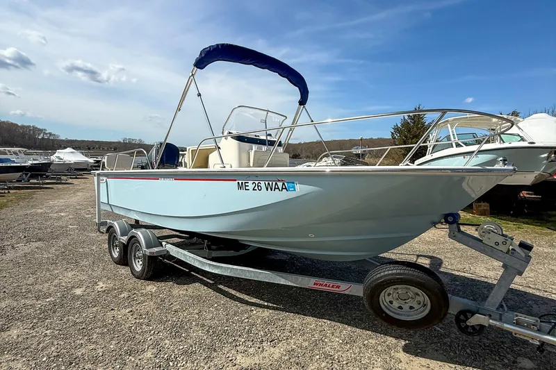 The Image of 2025 Boston Whaler 190 Montauk boat on trailer under clear blue sky. - 0