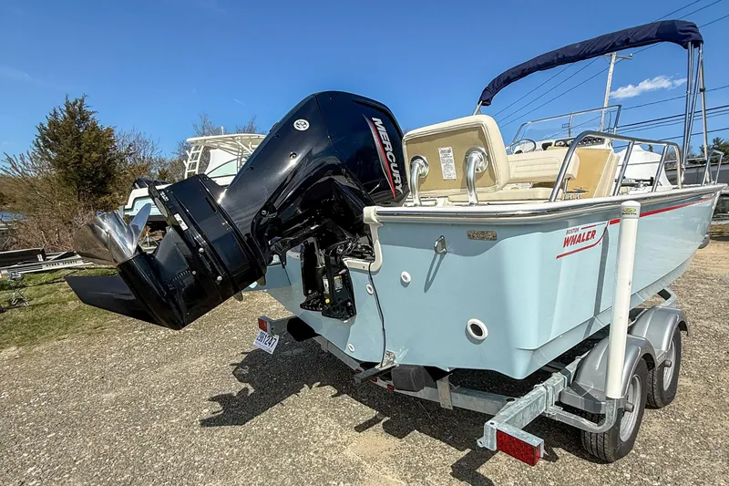 Slide: The Image of 2025 Boston Whaler 190 Montauk boat on trailer with Mercury outboard motor. - 3