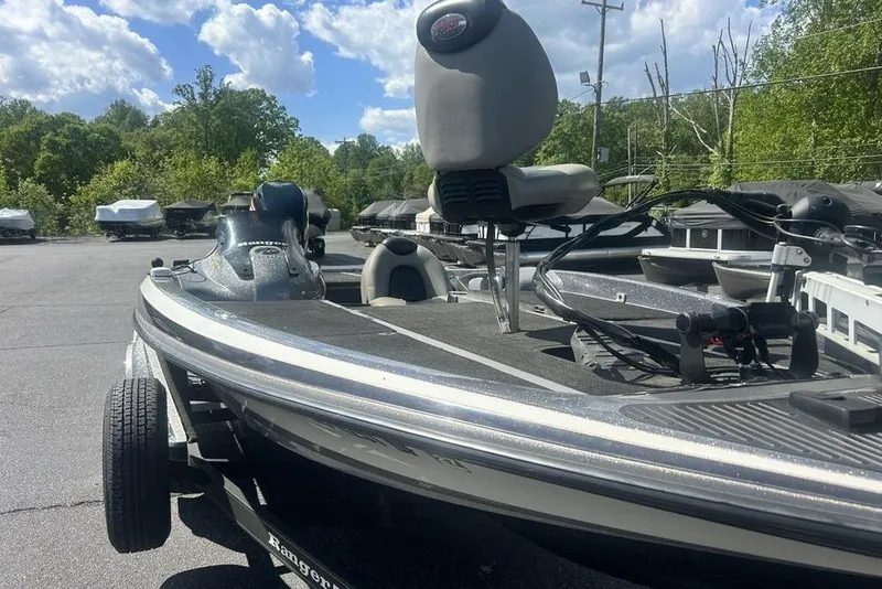 Slide: The Image of 2007 Ranger Z20 boat parked outdoors under a partly cloudy sky. - 12